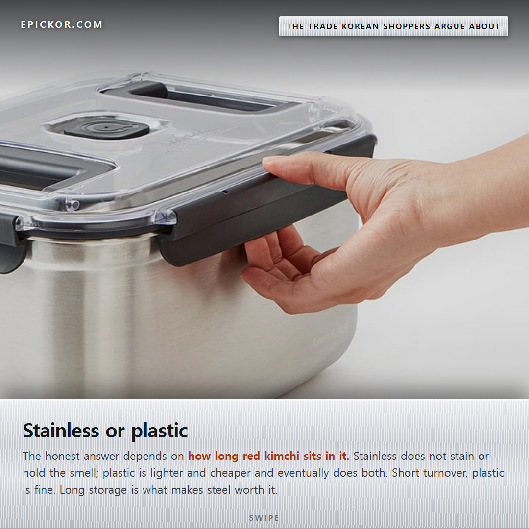 A hand releasing the locking latch on the clear lid of a brushed stainless kimchi container