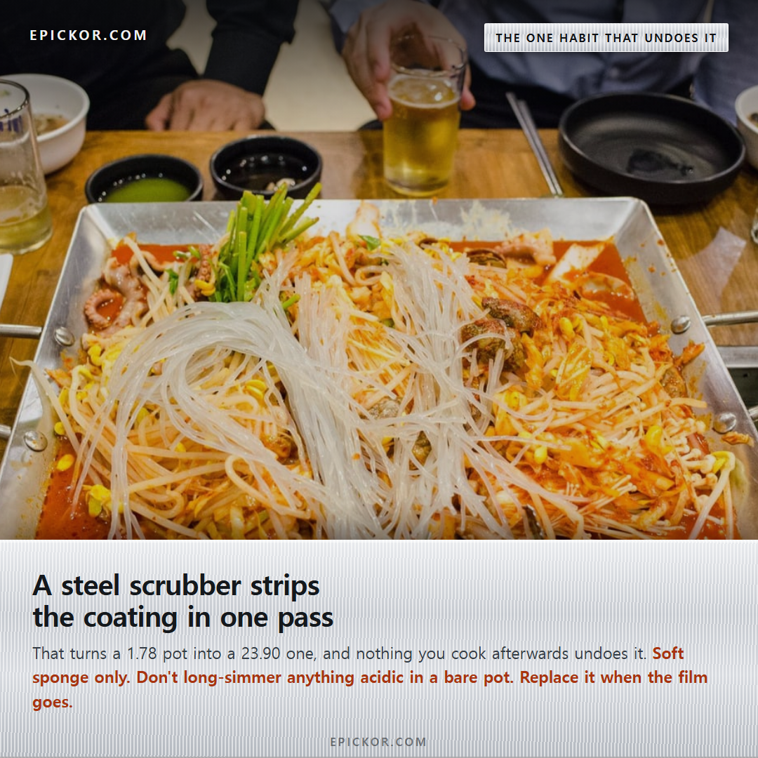 A Korean restaurant table with a square stainless griddle pan of seafood and glass noodles, banchan bowls, tongs and glasses around it