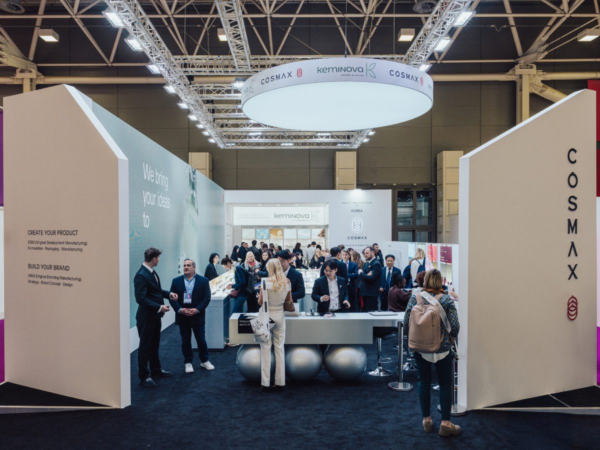 The COSMAX and Keminova booth at Cosmoprof Bologna 2026 shows buyers and beauty professionals meeting at the trade show.