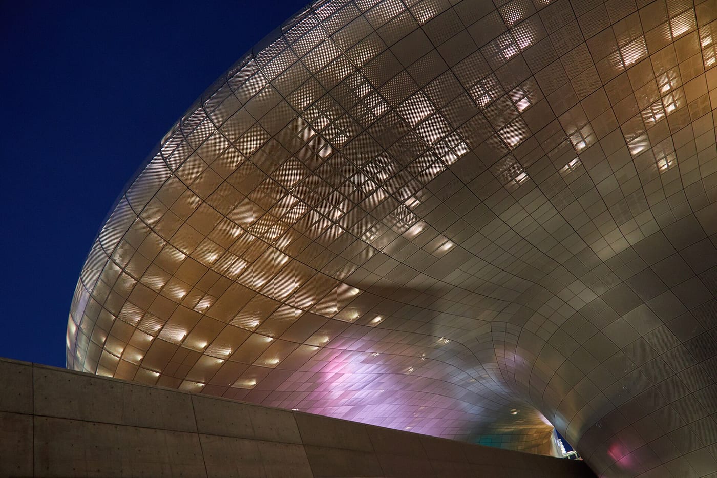Dongdaemun Design Plaza lit at night, the modern landmark of Seoul's fashion district.