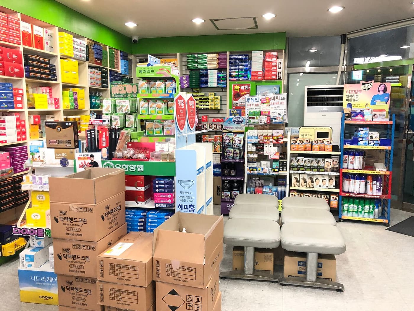Interior of a Korean pharmacy with shelves of supplements including lutein, milk thistle, and omega-3 products.