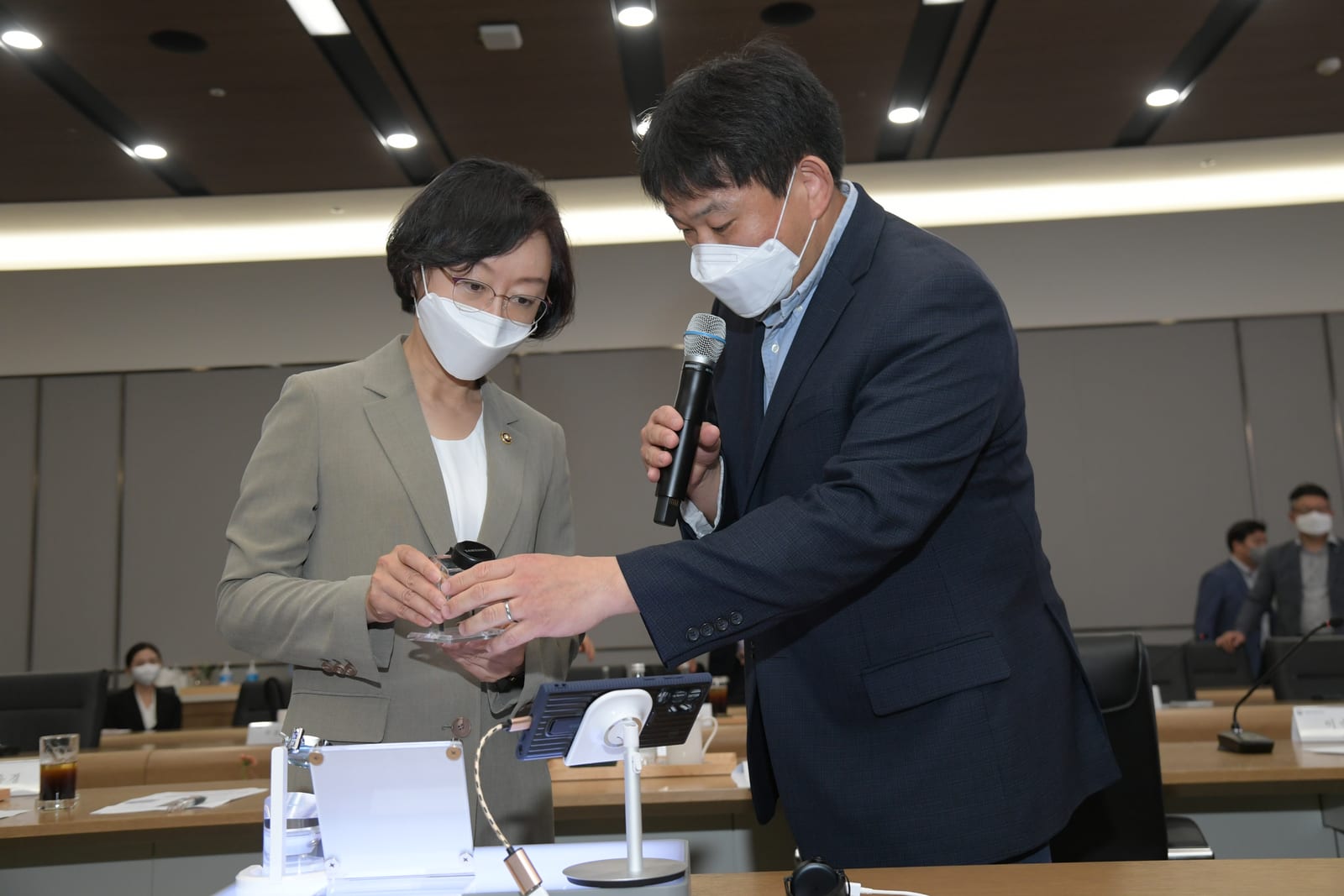 MFDS officials examine a digital medical-device demonstration during an official manufacturing-site visit.