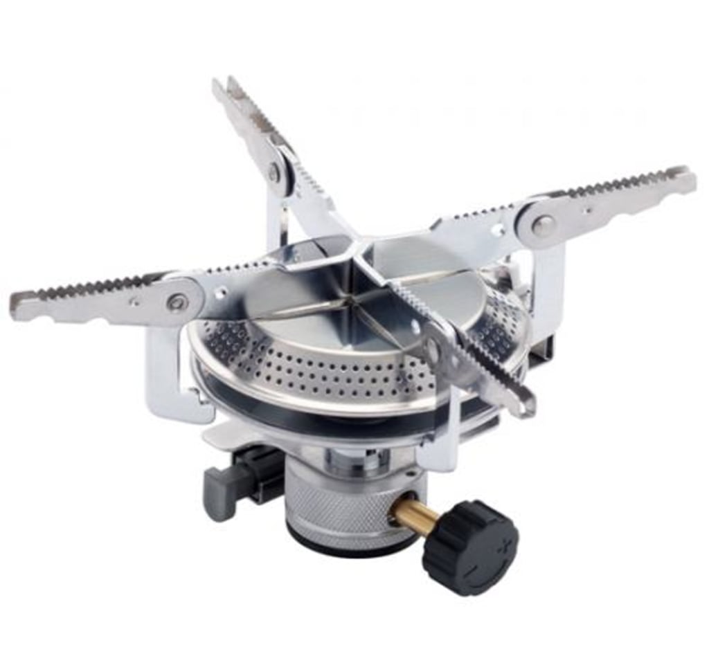 Kovea K1 camping stove: a compact stainless-steel canister-top burner with four serrated pot-support arms folded out, a perforated burner head, and a black control knob.