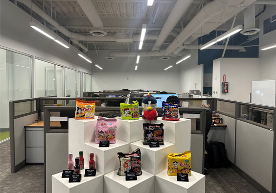 An official Samyang America office image displays Buldak noodles, sauces, and adjacent products as a regional portfolio rather than a single export SKU.