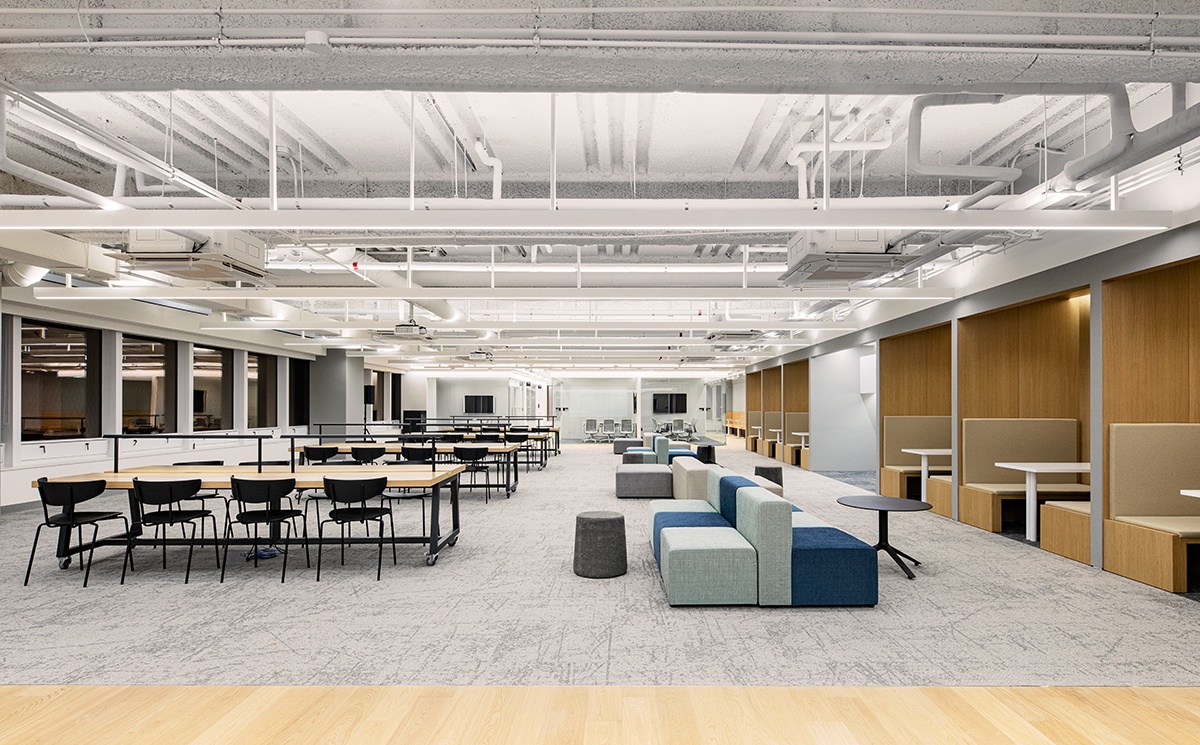 A wide view of Toss's office interior shows open desks, lounge seating, and collaboration zones inside the Seoul workspace.