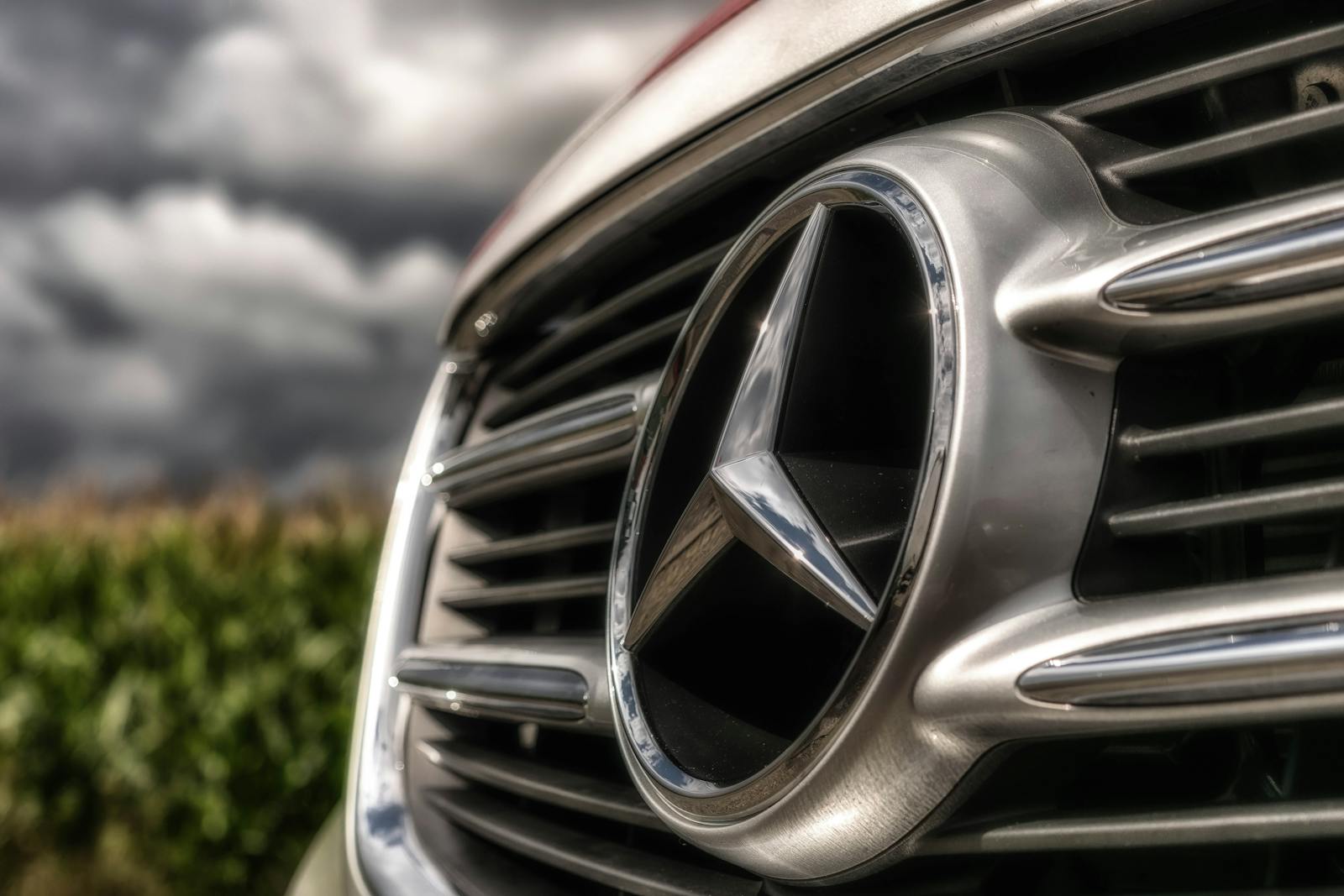 A close view of the Mercedes-Benz hood emblem, a recognizable premium-brand signal