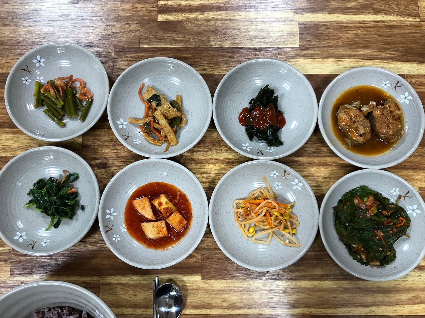 A spread of home-style Korean side dishes in small white bowls.