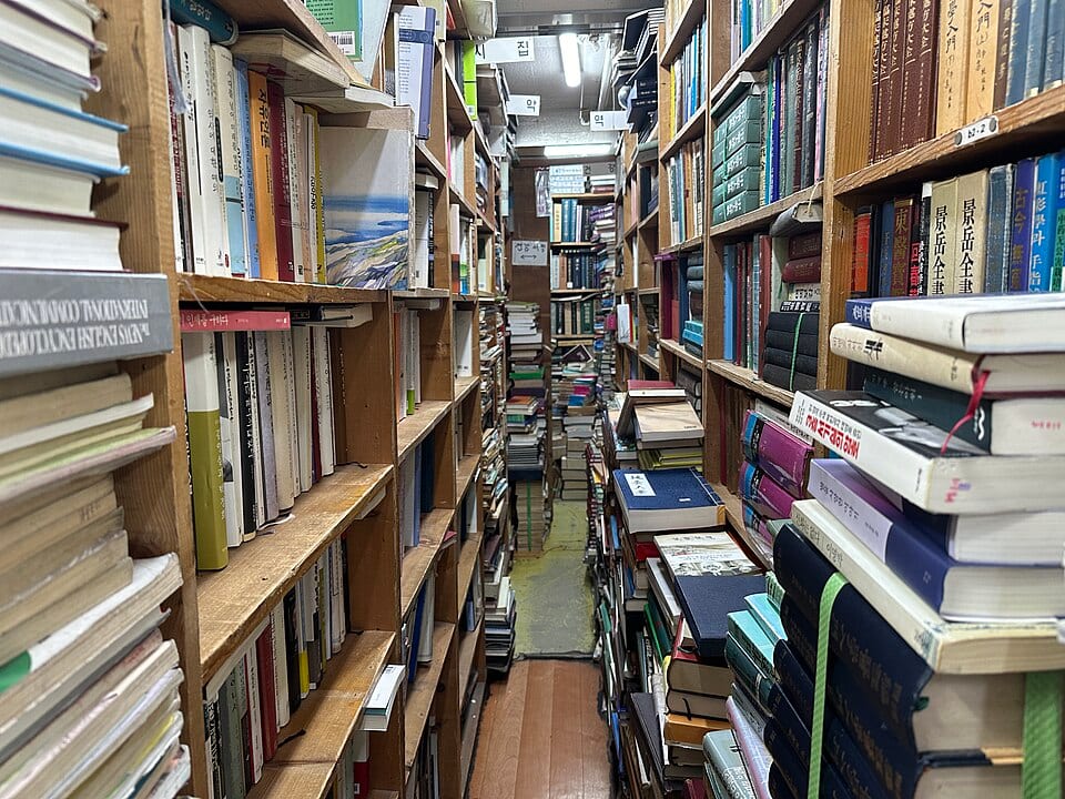 A narrow secondhand book shop inside Dongmyo Flea Market