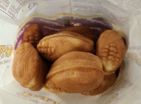 An opened retail pack of Deli Manjoo-style cakes, the corn-kernel pattern pressed into the top of each sponge.