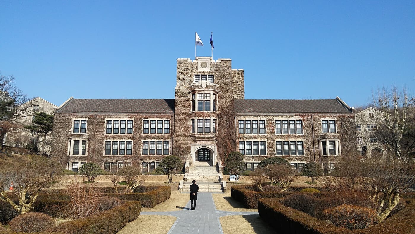 The Yonsei University campus in Seoul, its stone buildings seen across an open green.