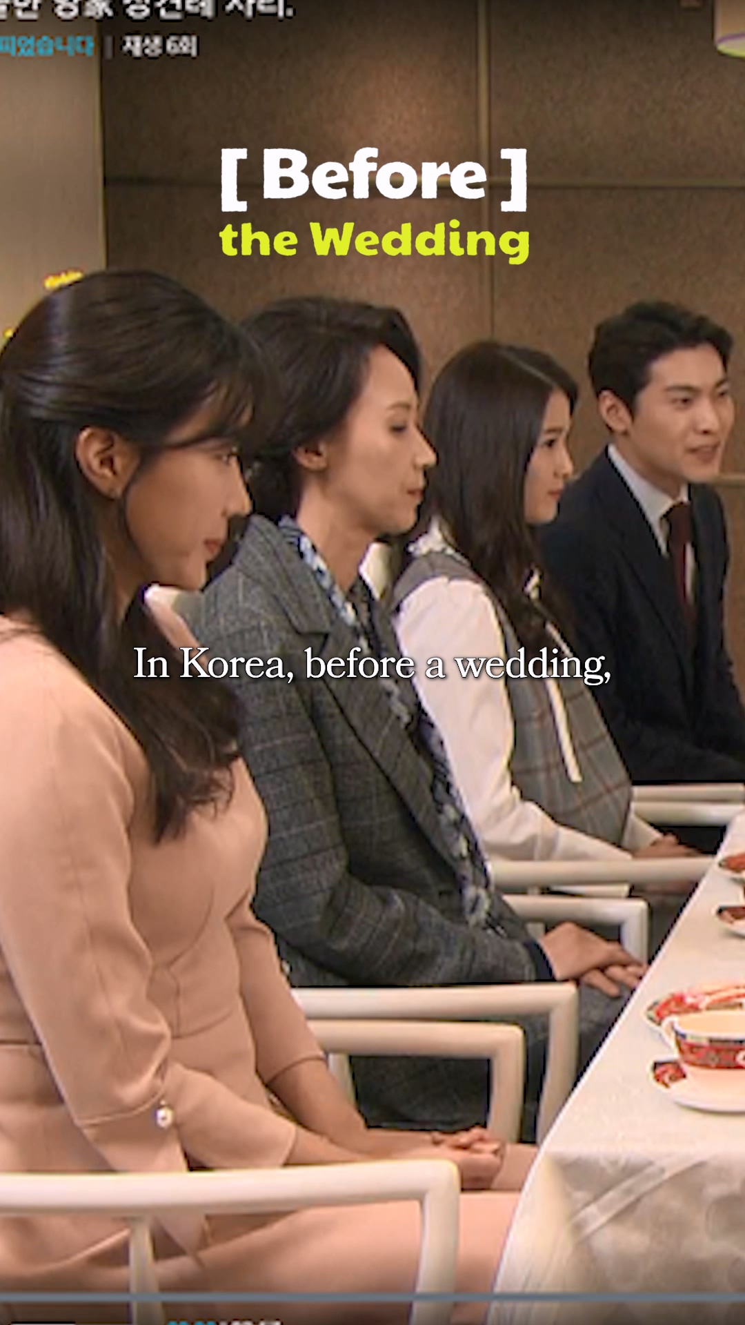 Families bowing to each other in a formal meeting room