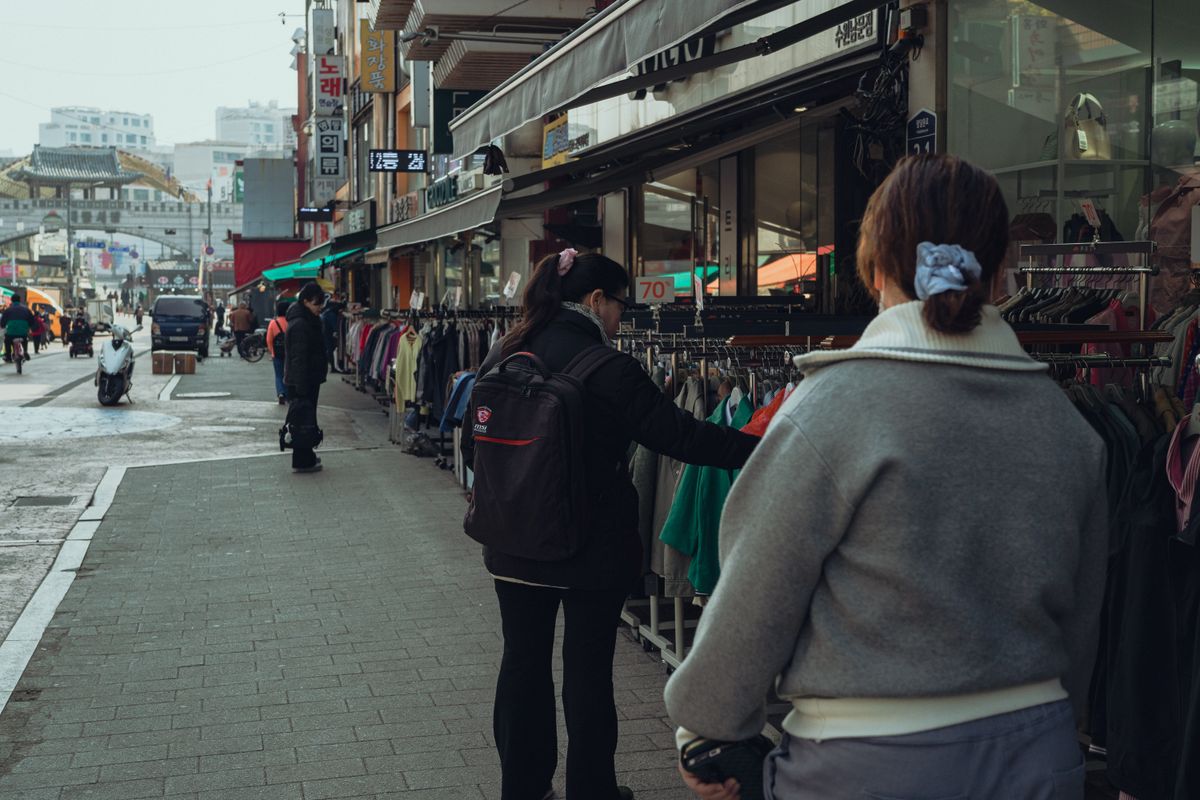 Street clothing racks in Seoul with visibly varied garments