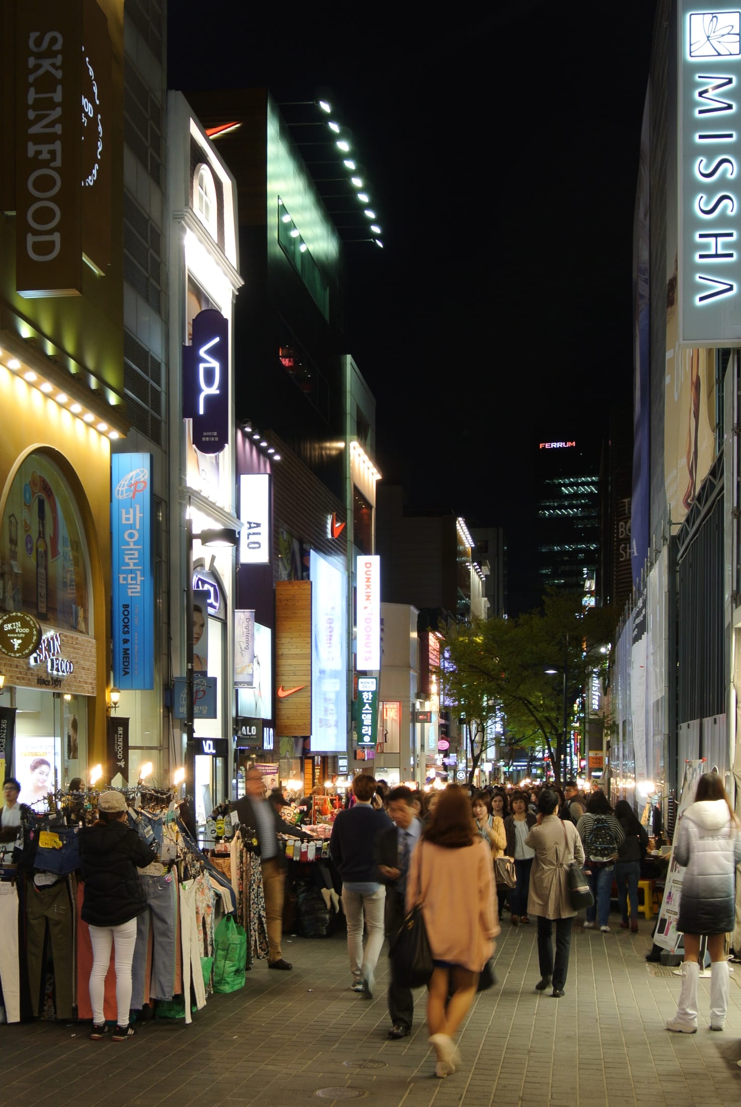 A Seoul night street with restaurants and lights.
