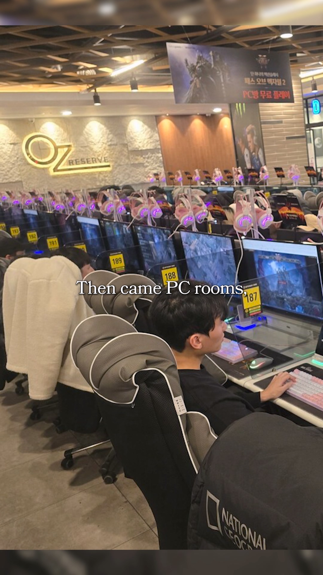 A tray of hot ramen and a burger served at a PC desk