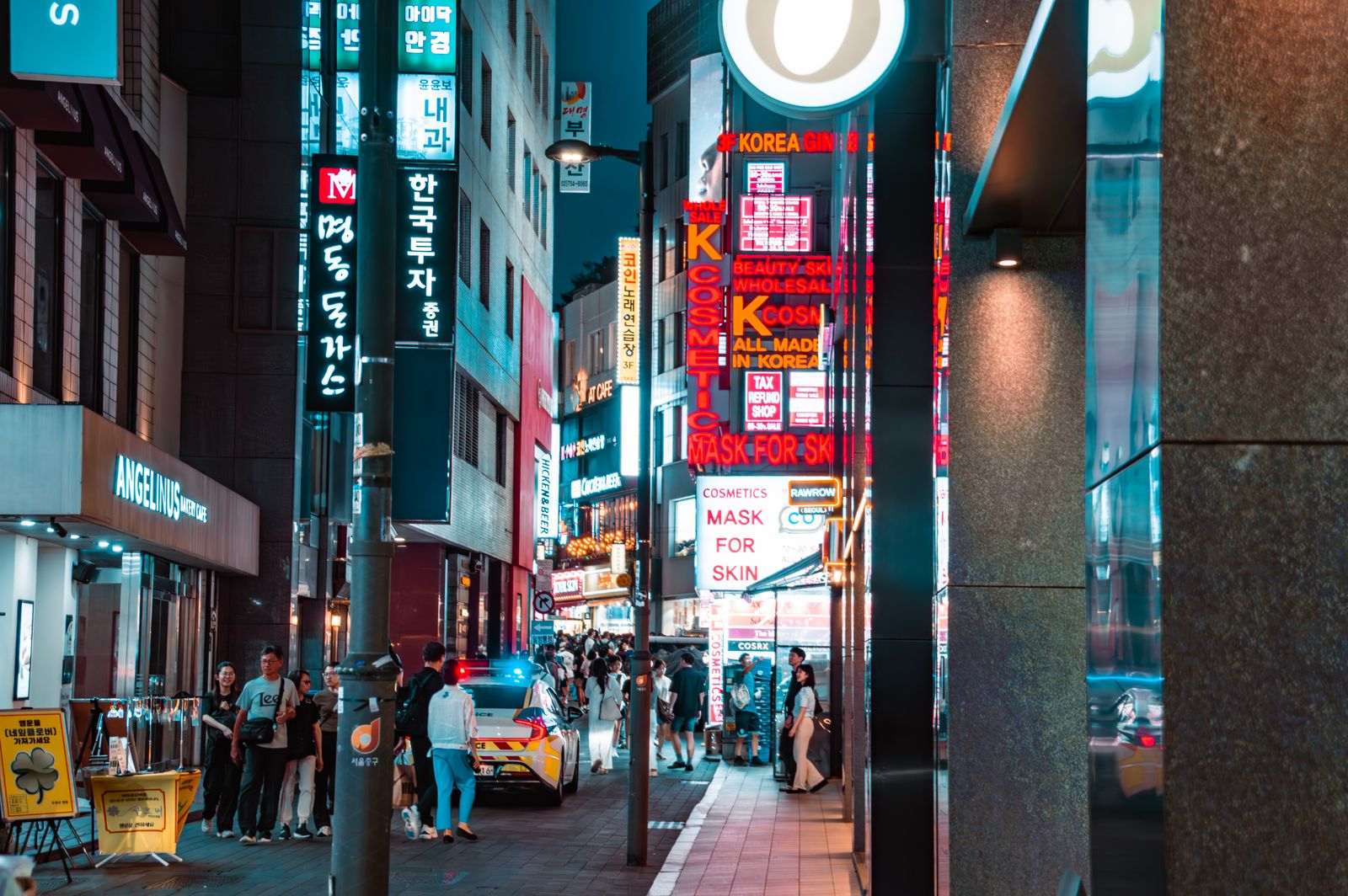 Myeongdong at night with Korean shopping signs and K-pop retail nearby