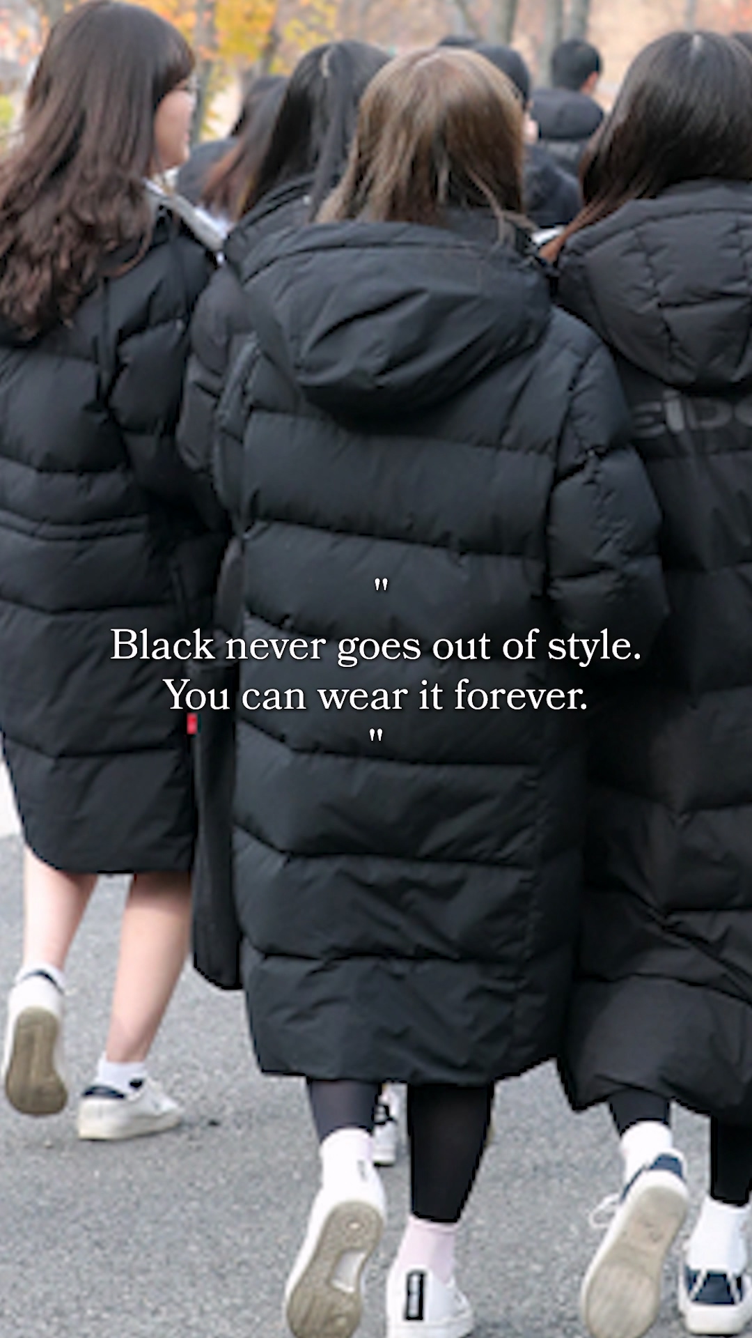 Night view of a Seoul street with pedestrians in dark clothing