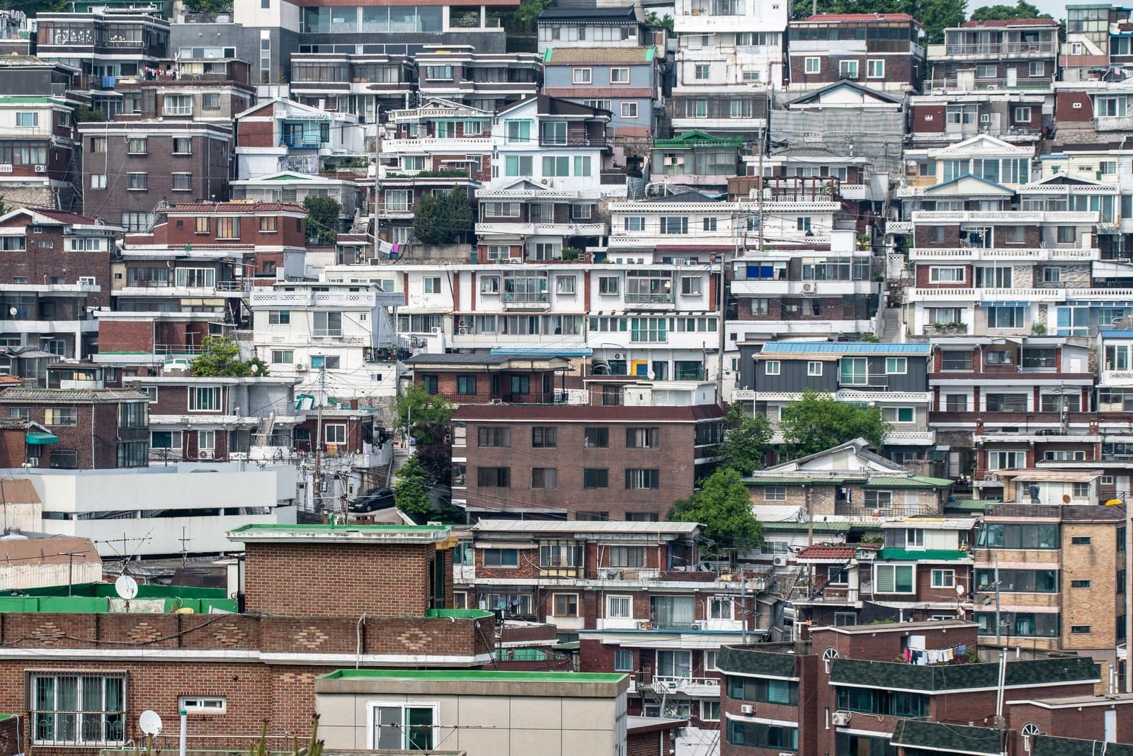Dense low-rise villa housing stacked across a Seoul hillside.