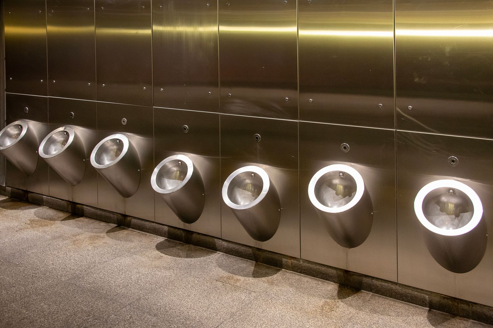 A clean modern public restroom interior with stainless fixtures