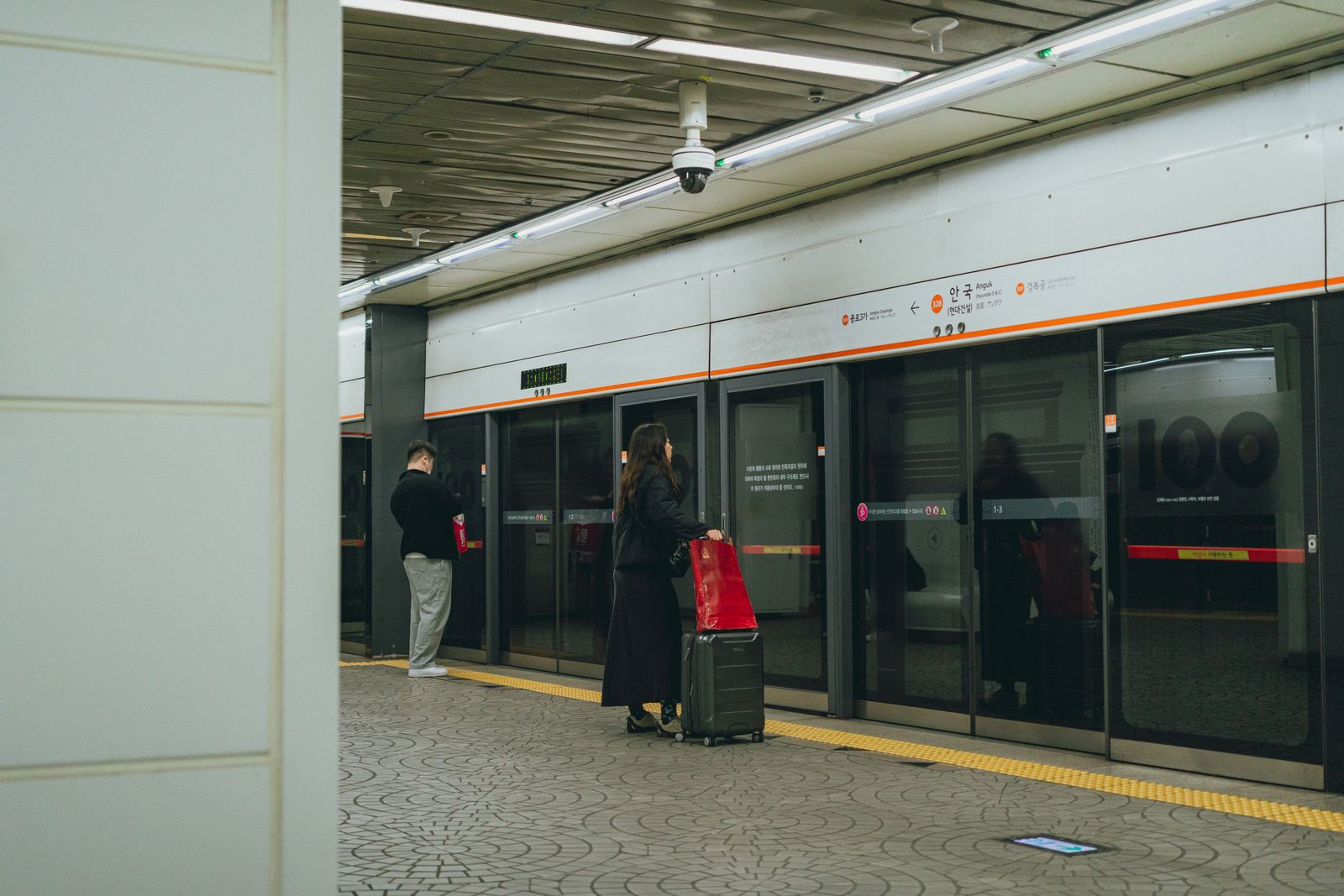Passengers waiting on a platform in the Seoul subway system