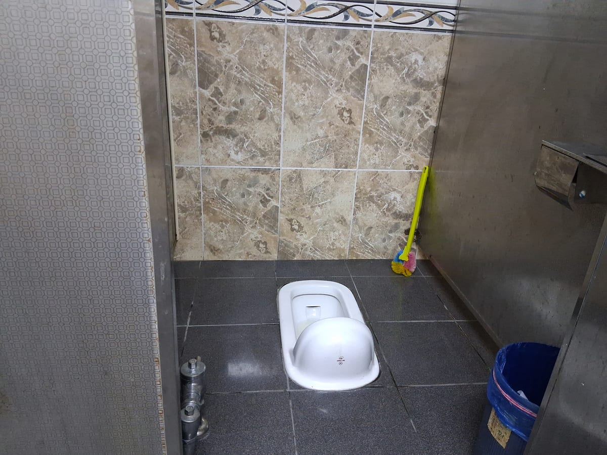 A squat toilet (화변기) in a commercial building in Korea.