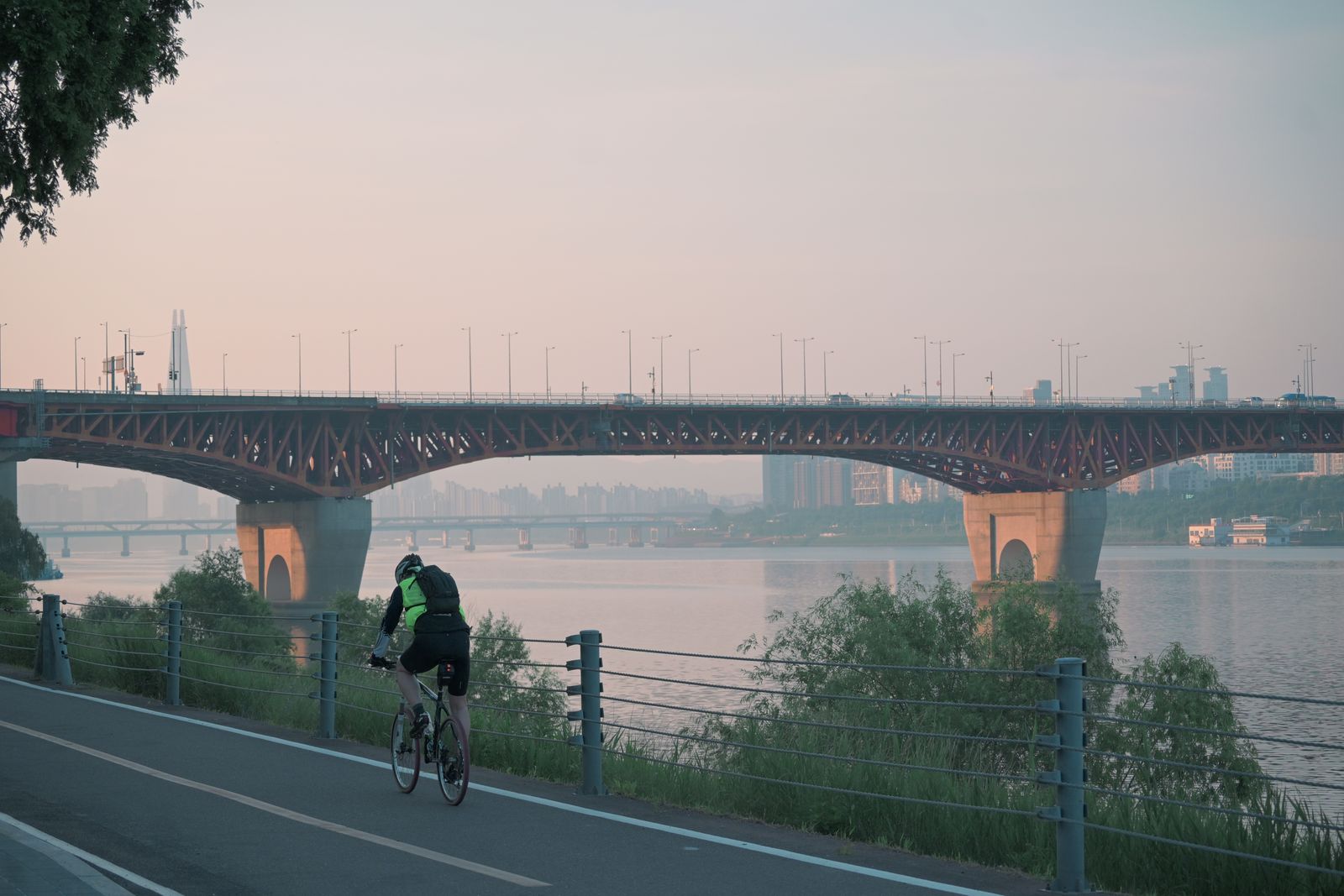 A riverside path below Seongsu Bridge at sunrise.