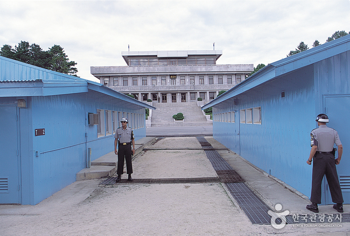 Blue conference buildings and guards at Panmunjeom's Joint Security Area