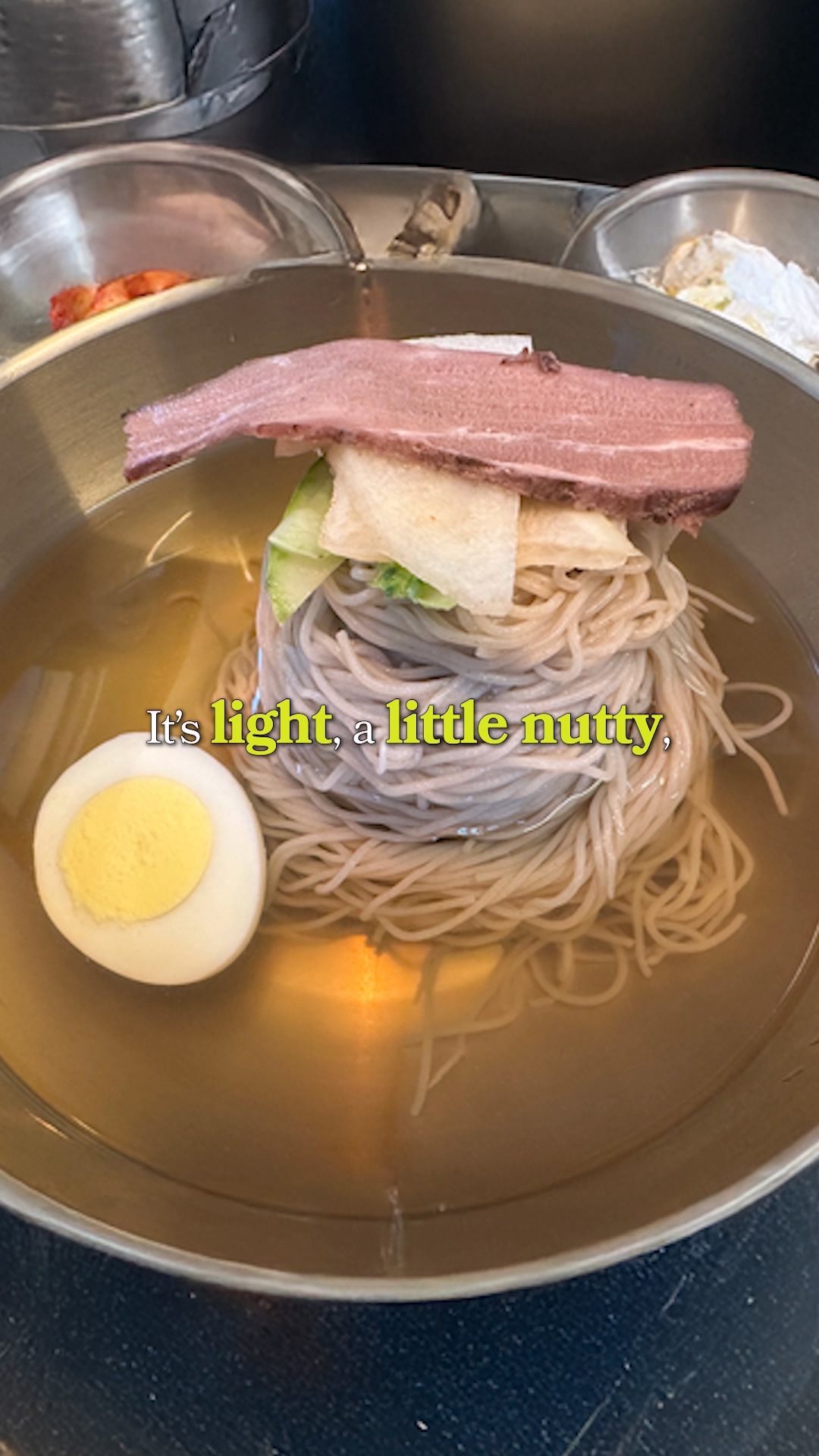 Adding vinegar and mustard to a bowl of noodles