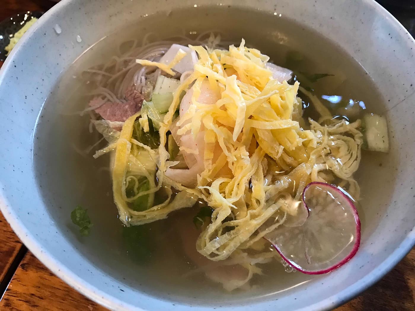 A bowl of mul-naengmyeon in chilled broth.