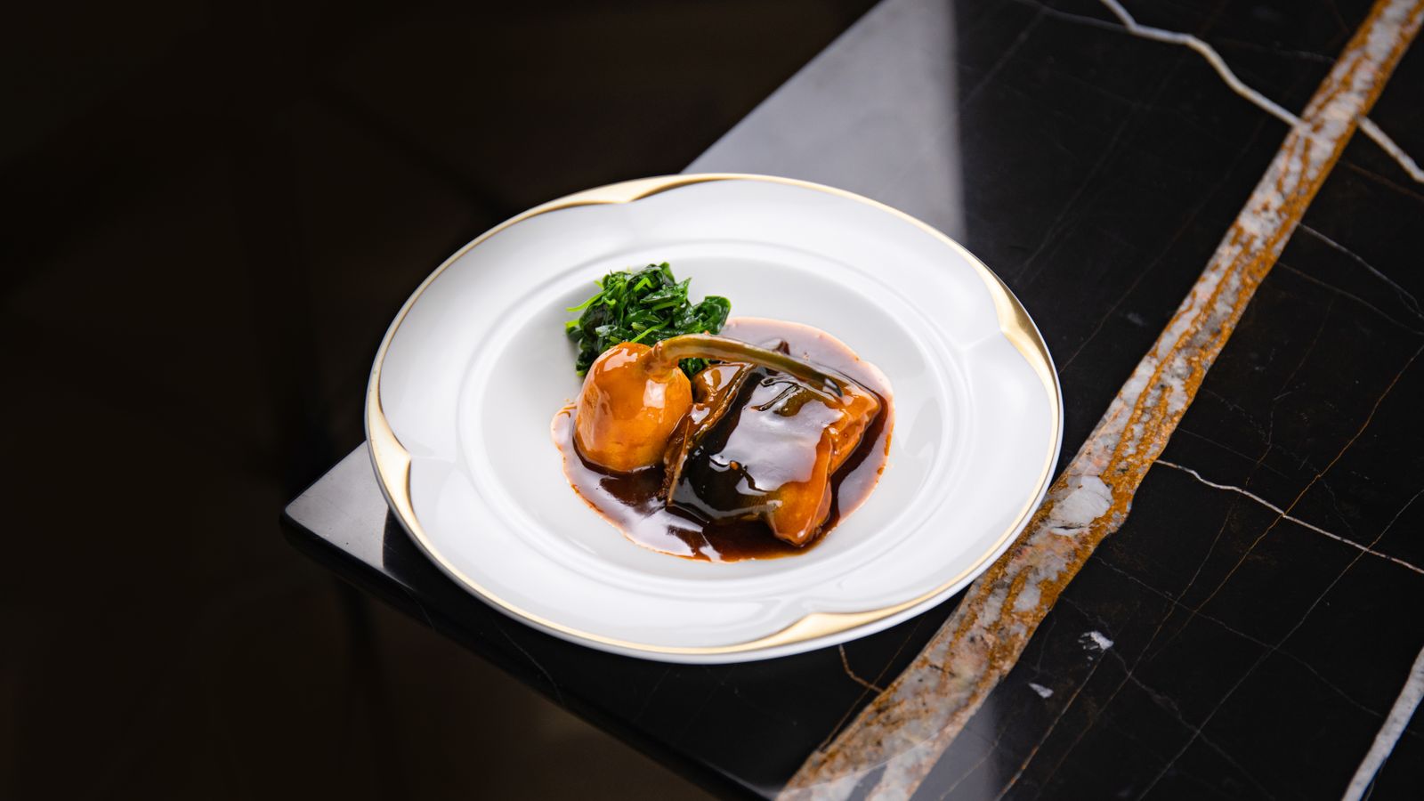 A carefully plated fine-dining dish with sauce and vegetables