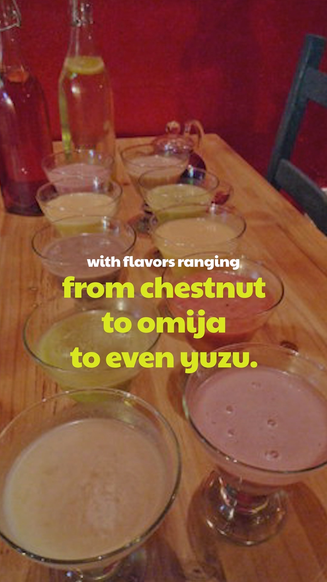 A group of friends toasting with Makgeolli bowls in a cozy pub