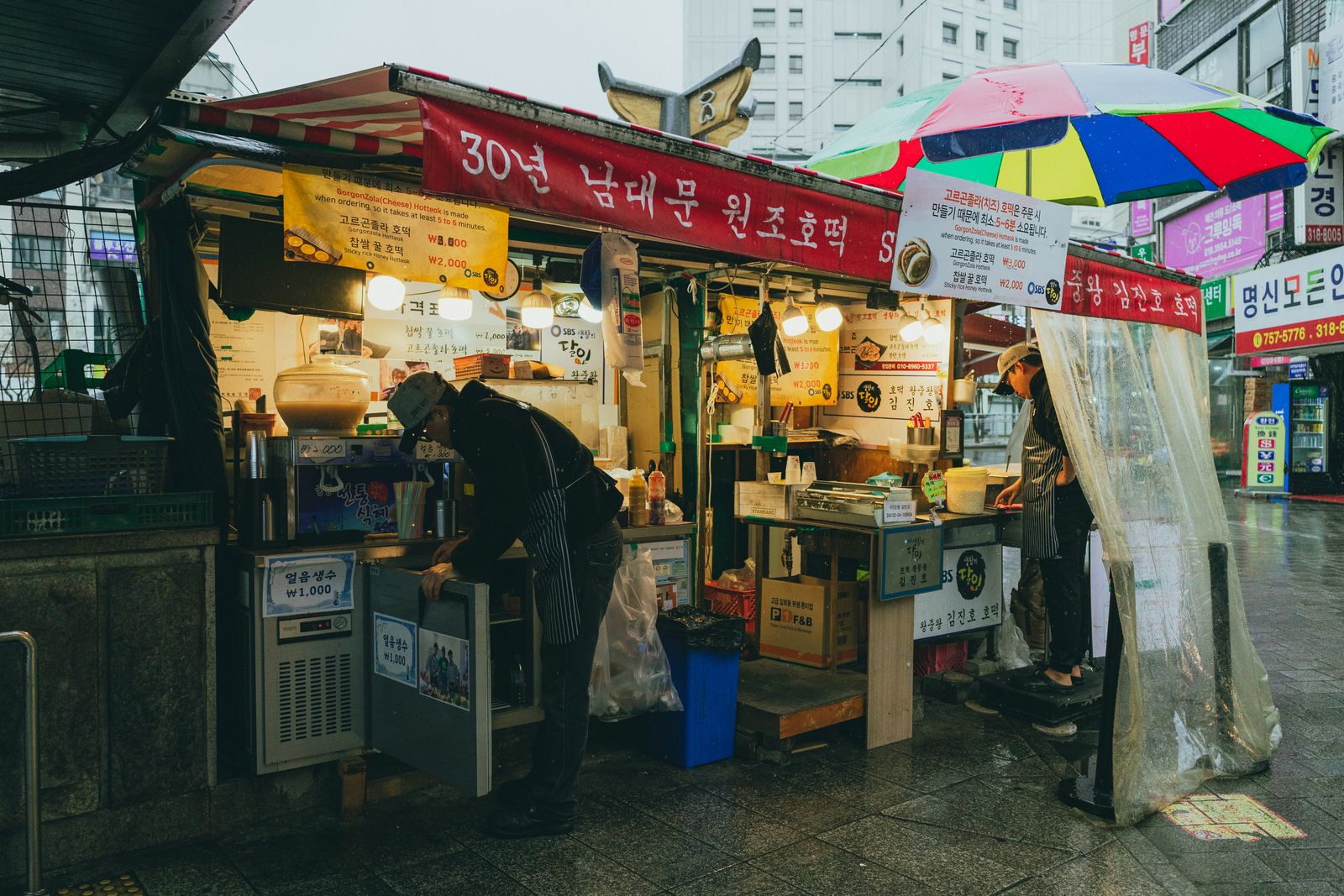 A Seoul market street on a rainy evening
