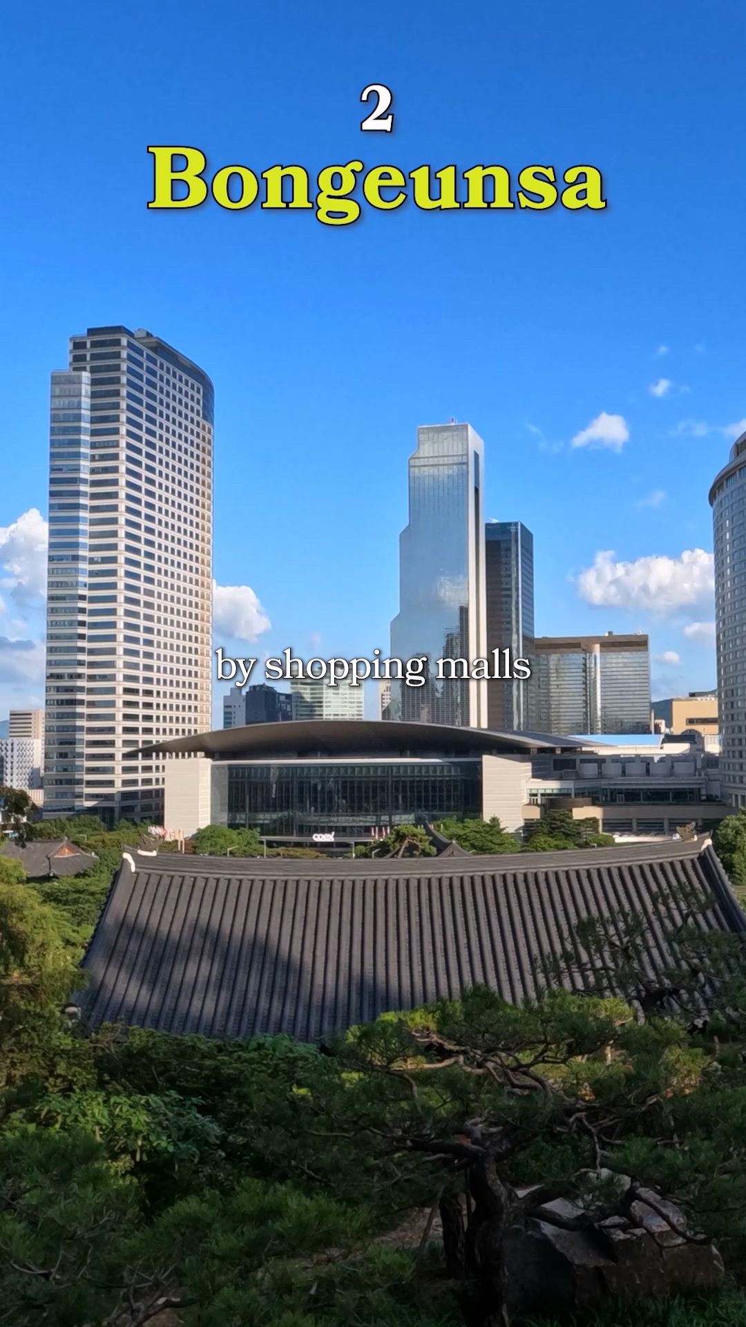 The giant Buddha statue at Bongeunsa with skyscrapers in the background
