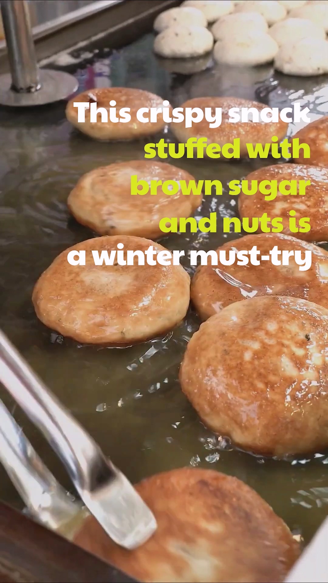 Someone wrapping a piece of Bossam in a lettuce leaf