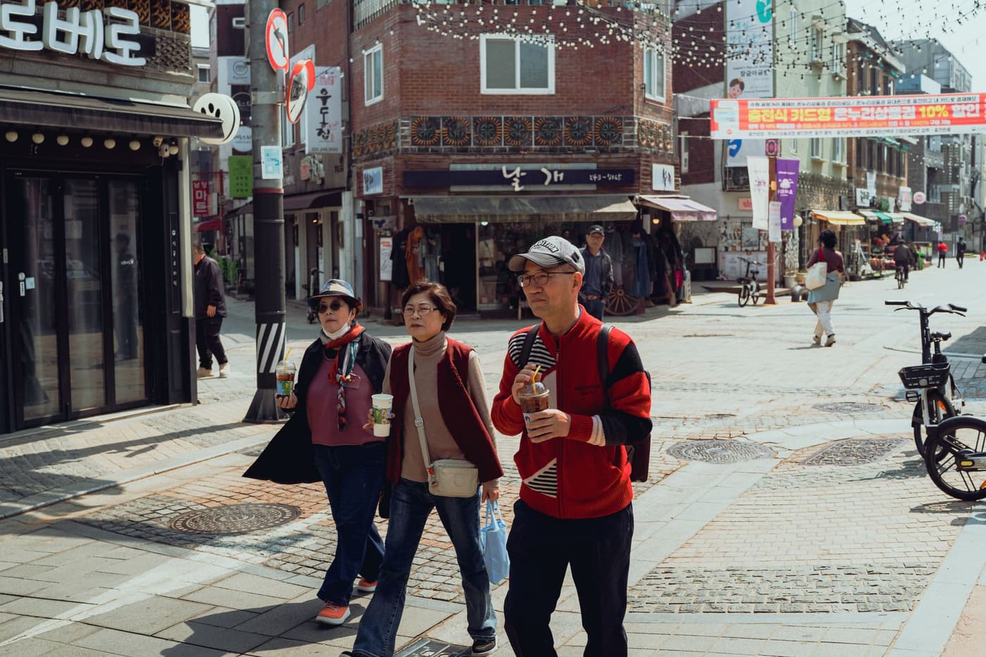 People walking through lively streets in Suwon, South Korea