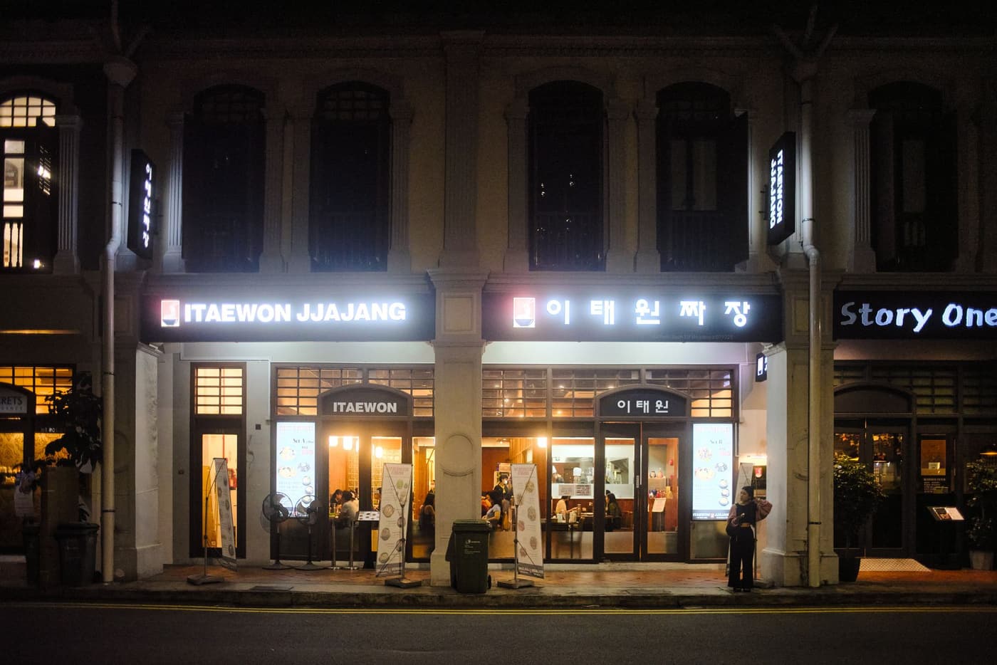 A night street in Itaewon with restaurant signs and city lights