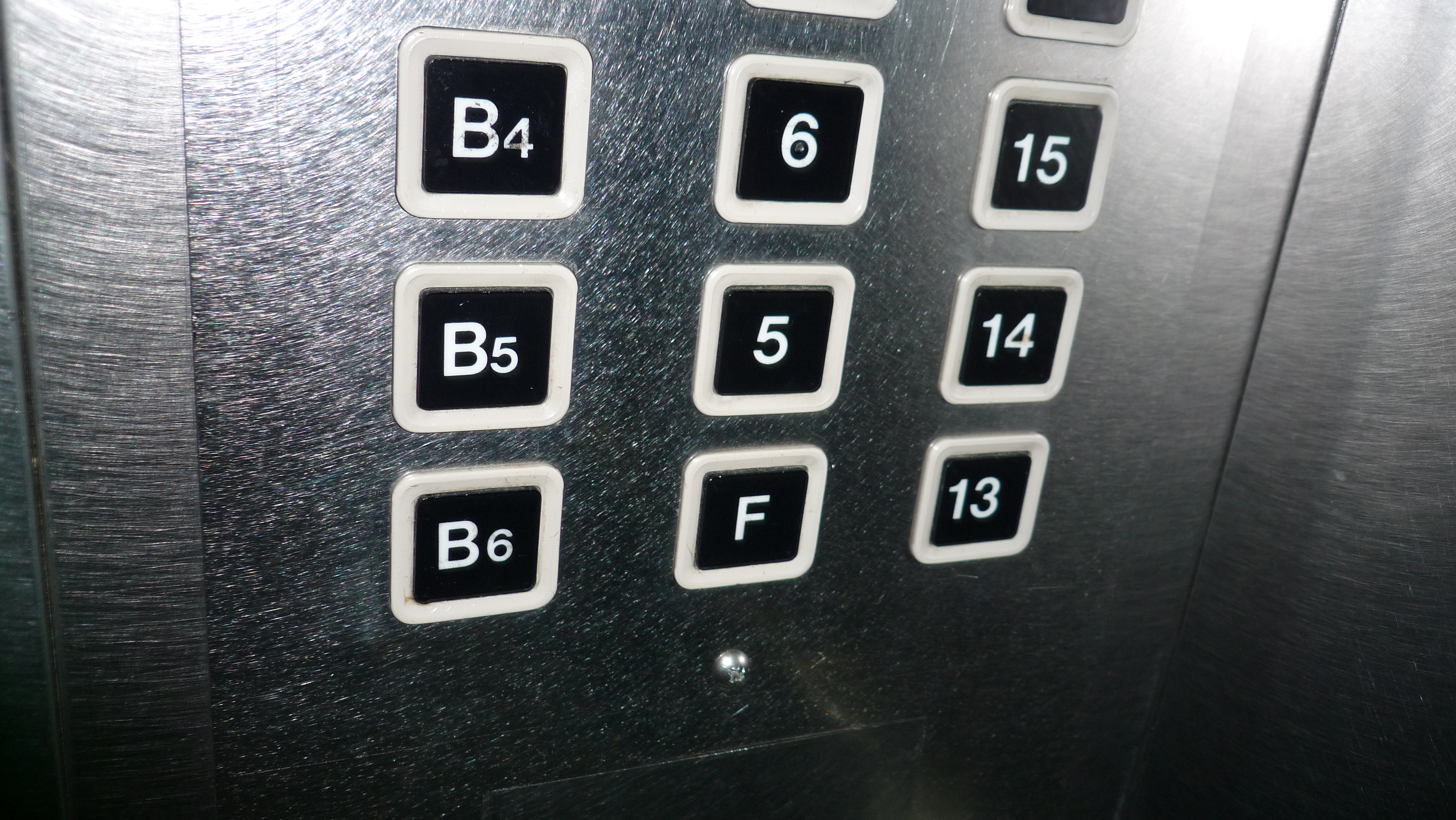 An elevator panel in Korea using F instead of the fourth floor number, one of the clearest everyday signs of the number-four superstition.