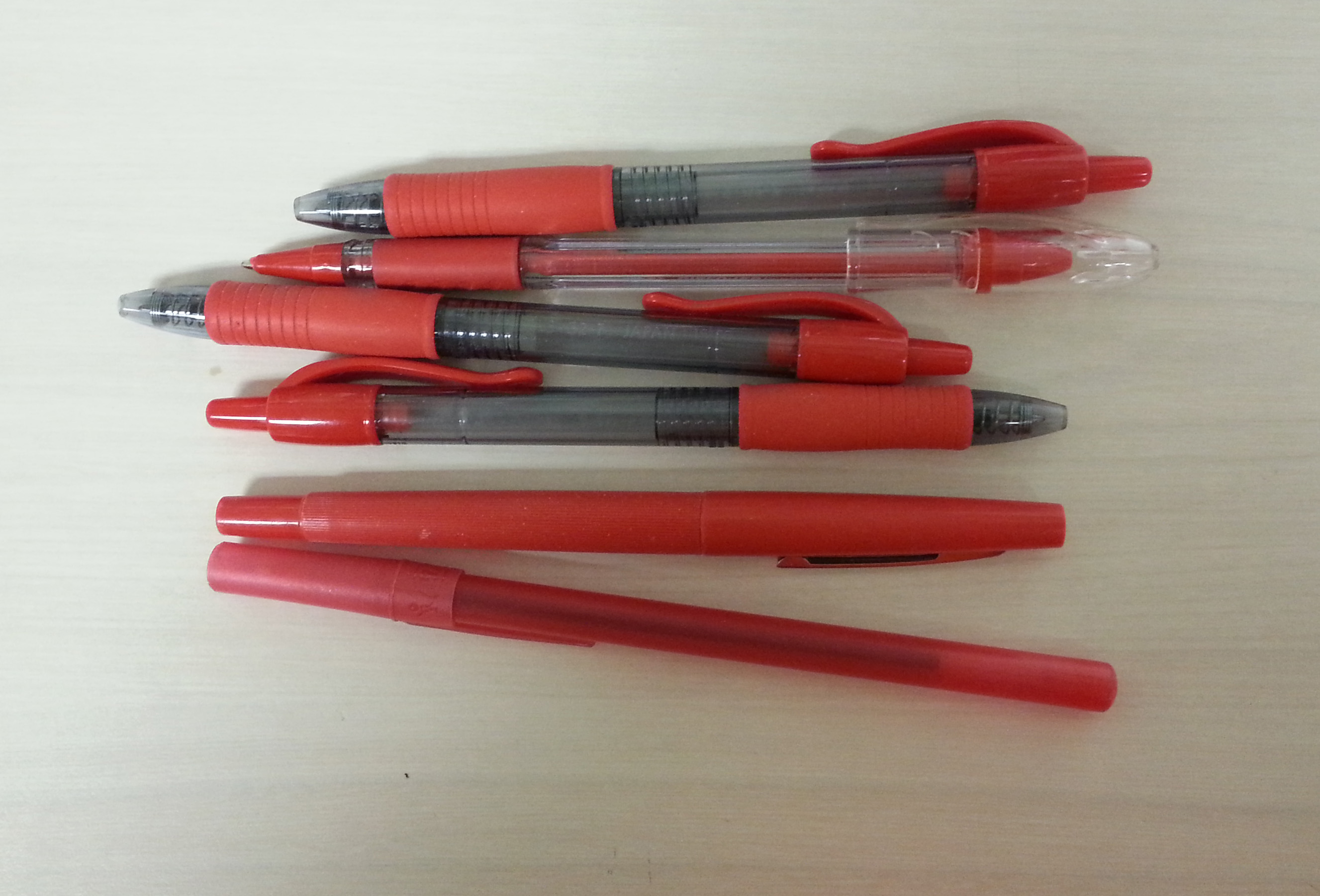 Several red pens on a desk, a simple reminder that the Korean taboo is not red ink itself but writing a living person's name in red.
