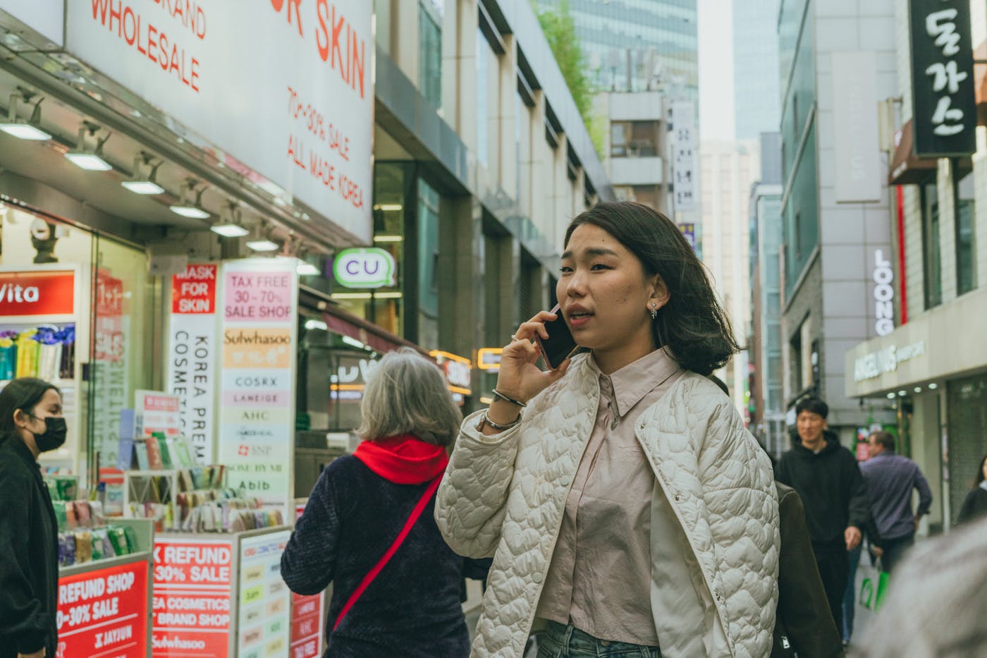 A busy Seoul shopping street, the kind of district where travelers often combine Olive Young, cafes, fashion stores, and street browsing.