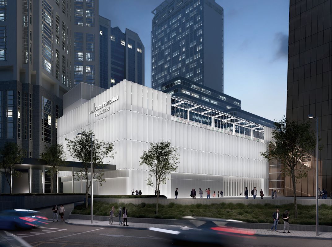A night rendering of Centre Pompidou Hanwha Seoul glowing as a white cultural volume among Yeouido office towers.