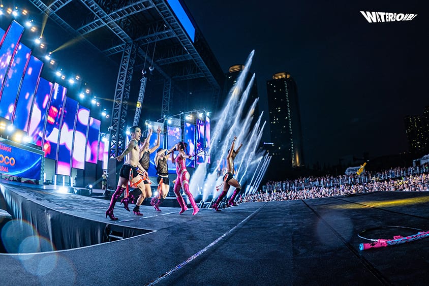 Performers on the Waterbomb stage as water cannons fire toward the audience