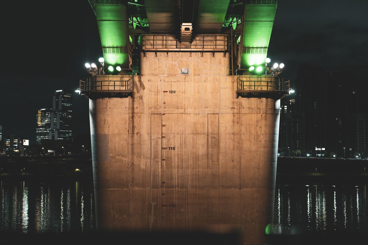 A brightly lit bridge over the Han River in Seoul.