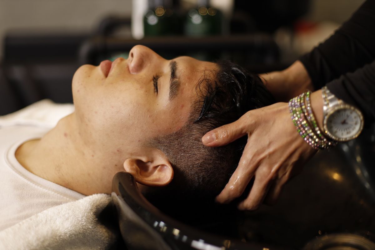 A salon hair-wash and head-spa style treatment, representing the relaxing side of scalp care.