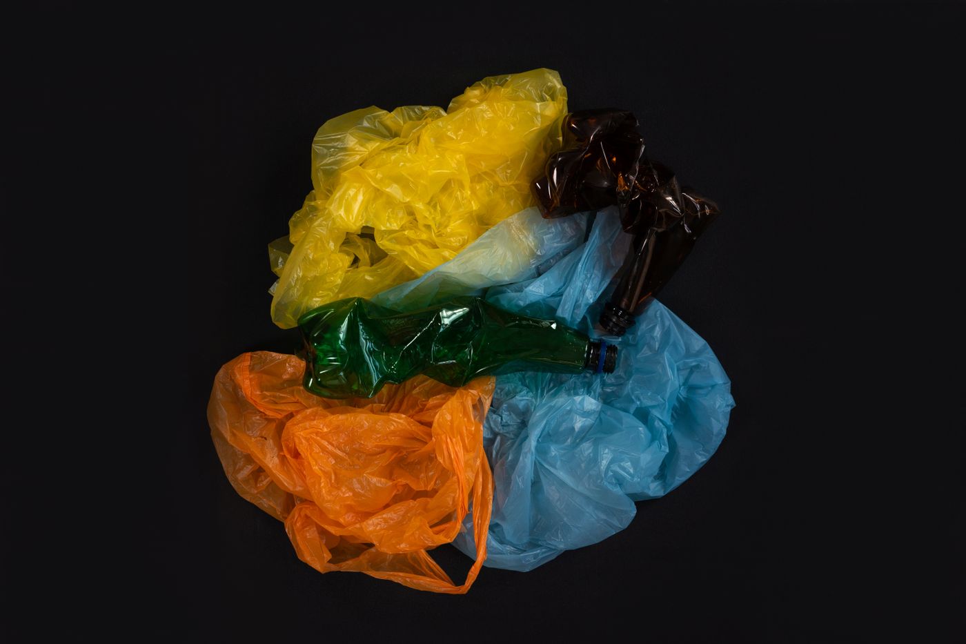 Neutral plastic and bottle waste showing why clean separation matters before recycling.