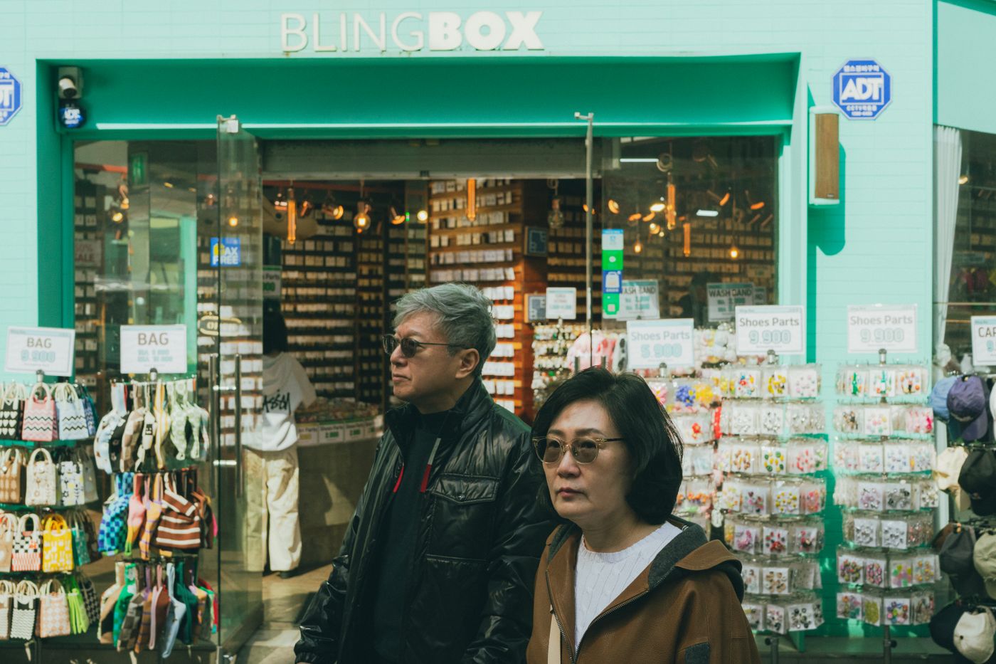 A clean Seoul storefront scene where tourists may carry cups longer than expected.