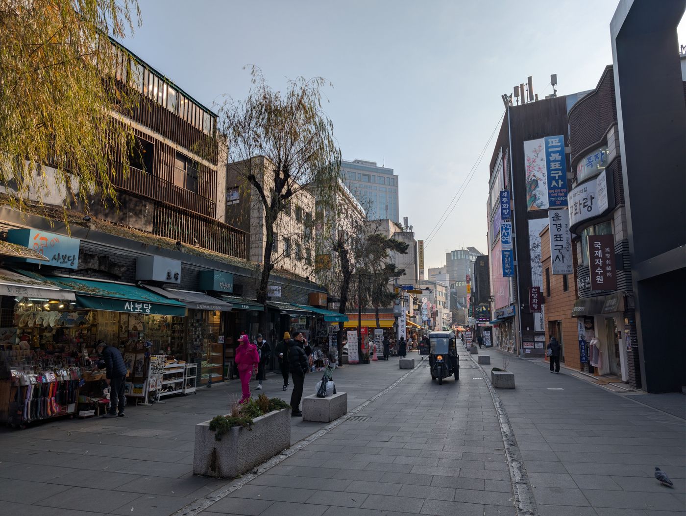 A Seoul side street with Korean storefronts and clean pedestrian space.