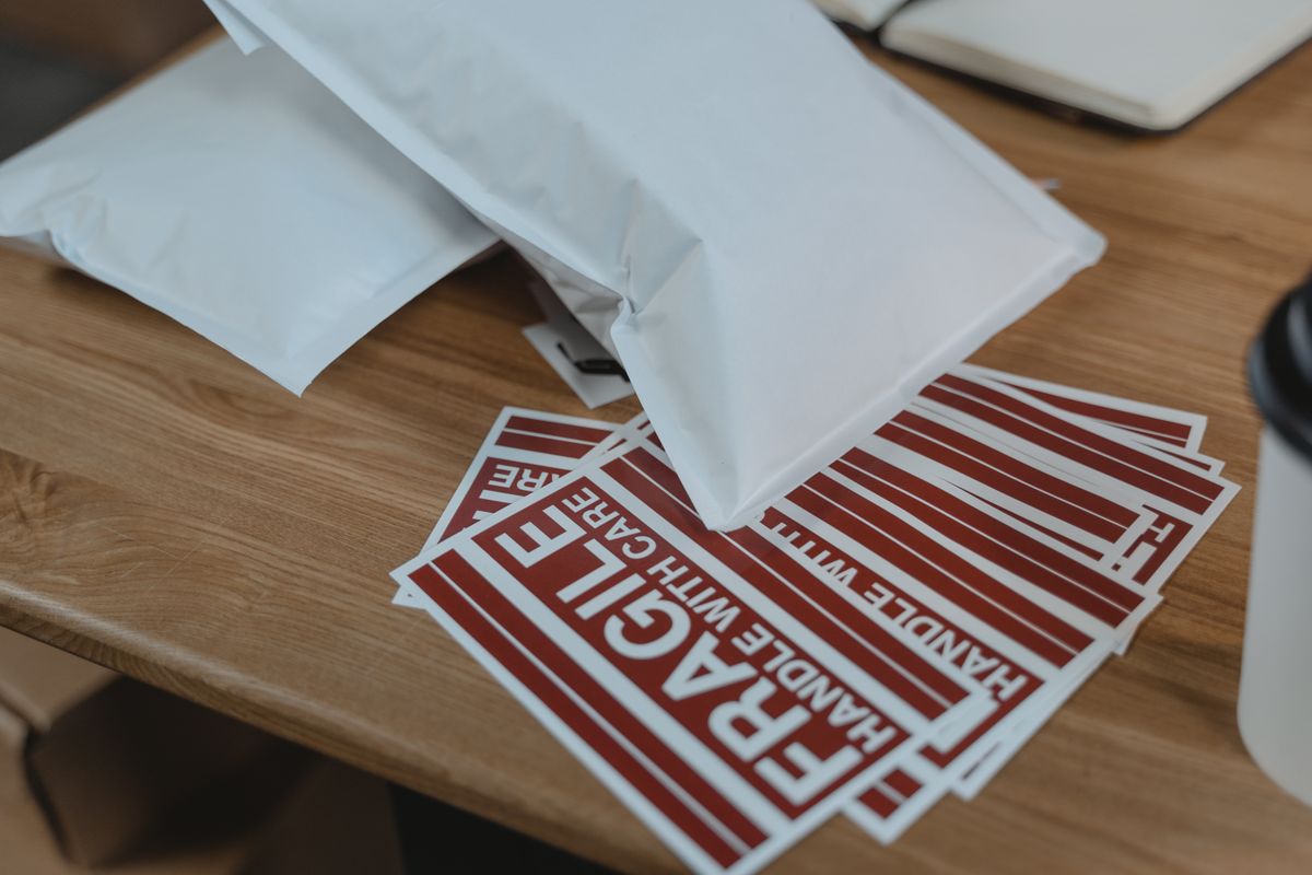 Mailing supplies and fragile stickers on a table.
