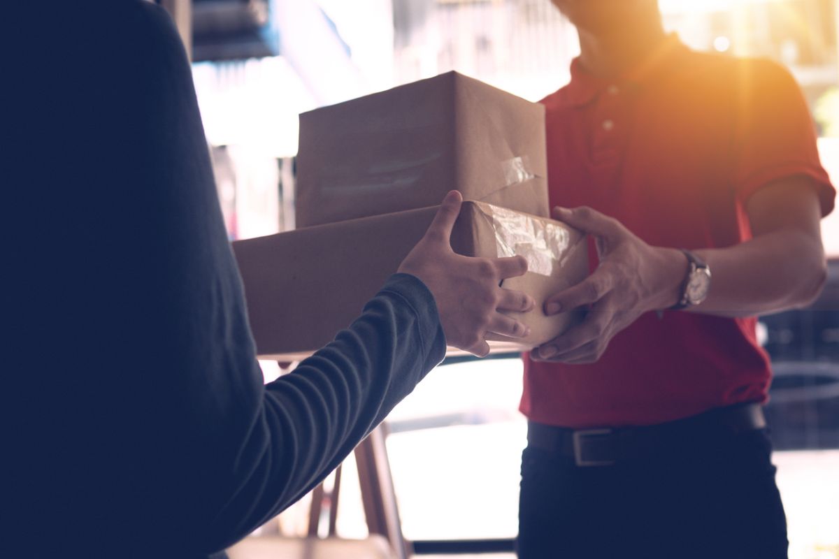 A package being handed over at a counter.