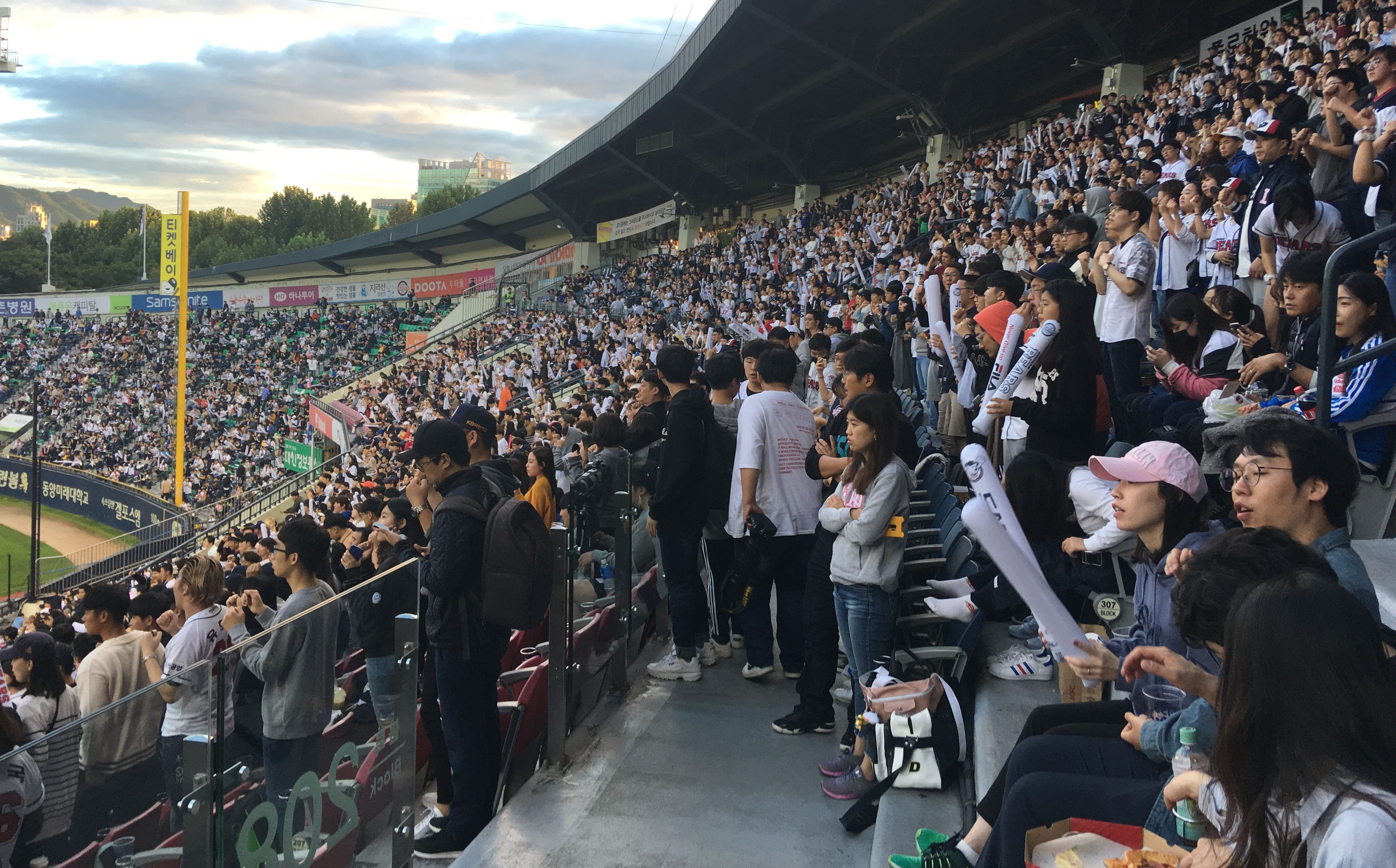 A packed cheering section at Jamsil Baseball Stadium in Seoul during a KBO game.
