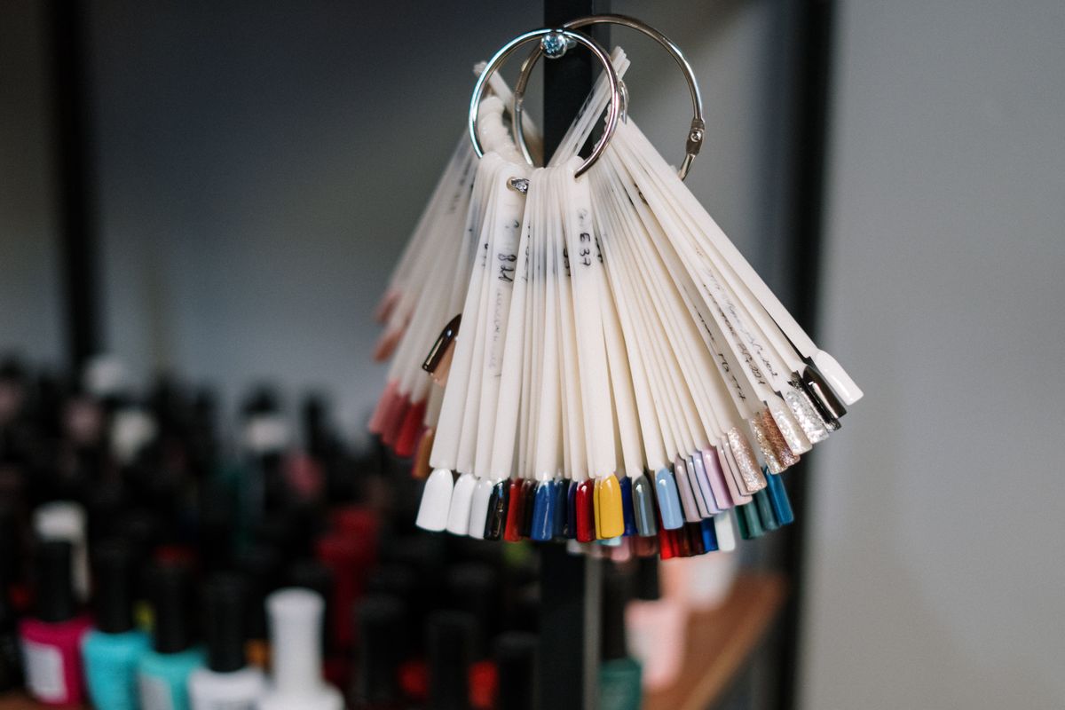 A ring of nail polish swatches in a salon setting.