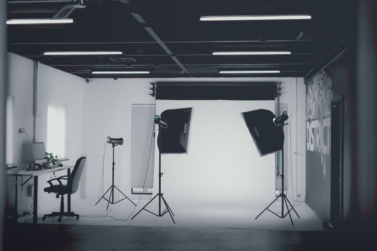 A simple photo studio with softbox lights and a clean backdrop.